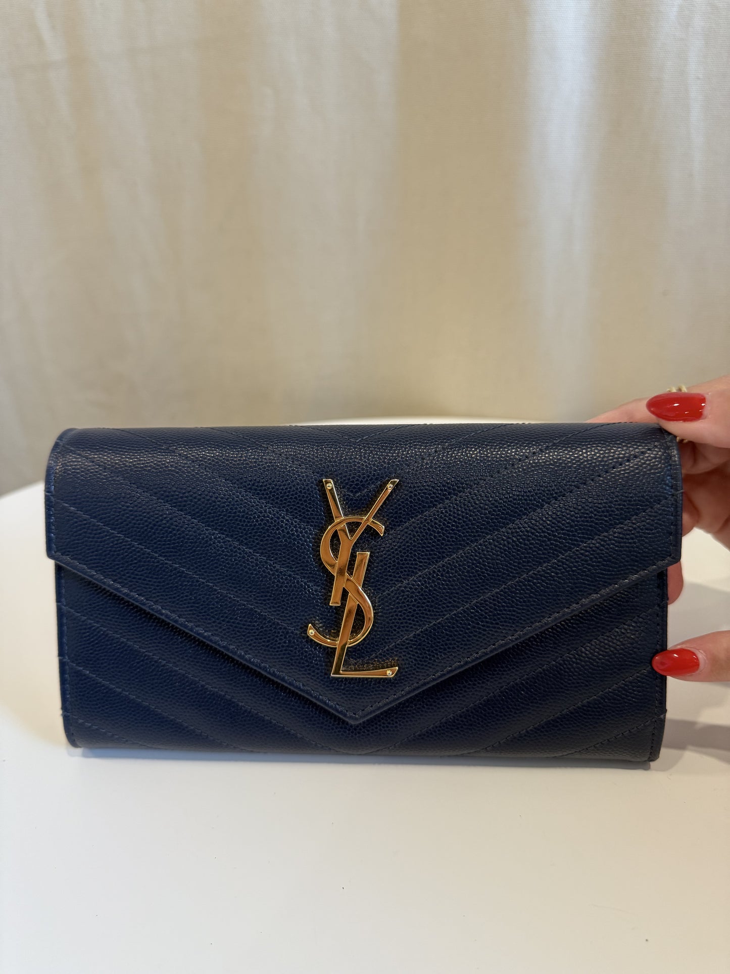 Yves saint Laurent Cassandra navy and gold wallet! Needs a seamstress to stitch one side . Maybe a $25 fix .. wallet retails for $900 Google it.