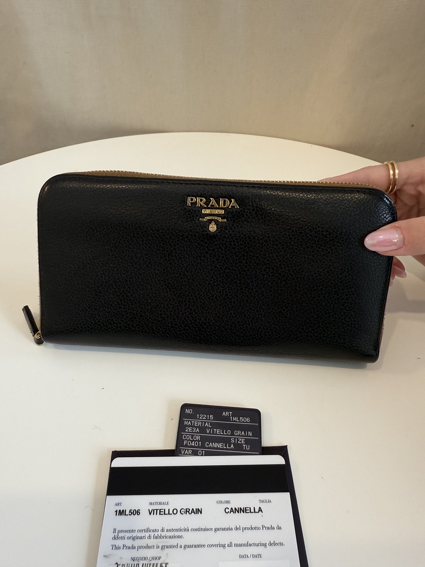 Prada black with brown interior zip around wallet with authenticity card. Retail $1250