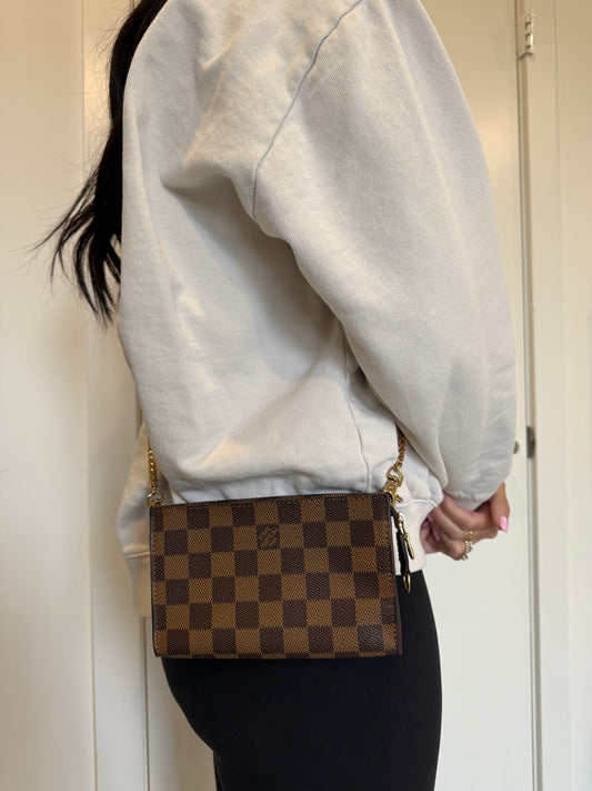 Louis Vuitton damier ebene cosmetic clutch in absolute pristine condition inside and out with added strap and original box . Phones fit