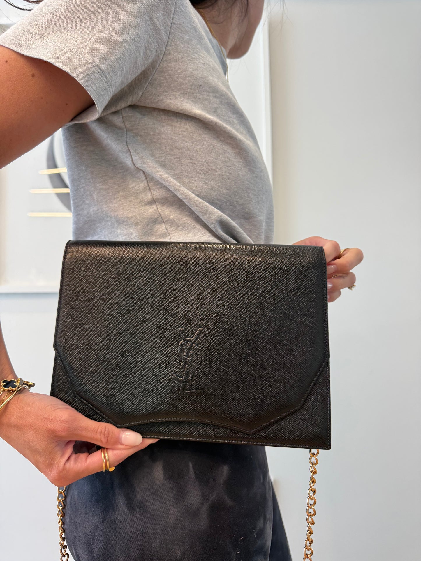 Authentic Yves Saint Laurent Flap Black brand new condition crossbody clutch with added removeable straps! Fits phones wallets keys makeup
