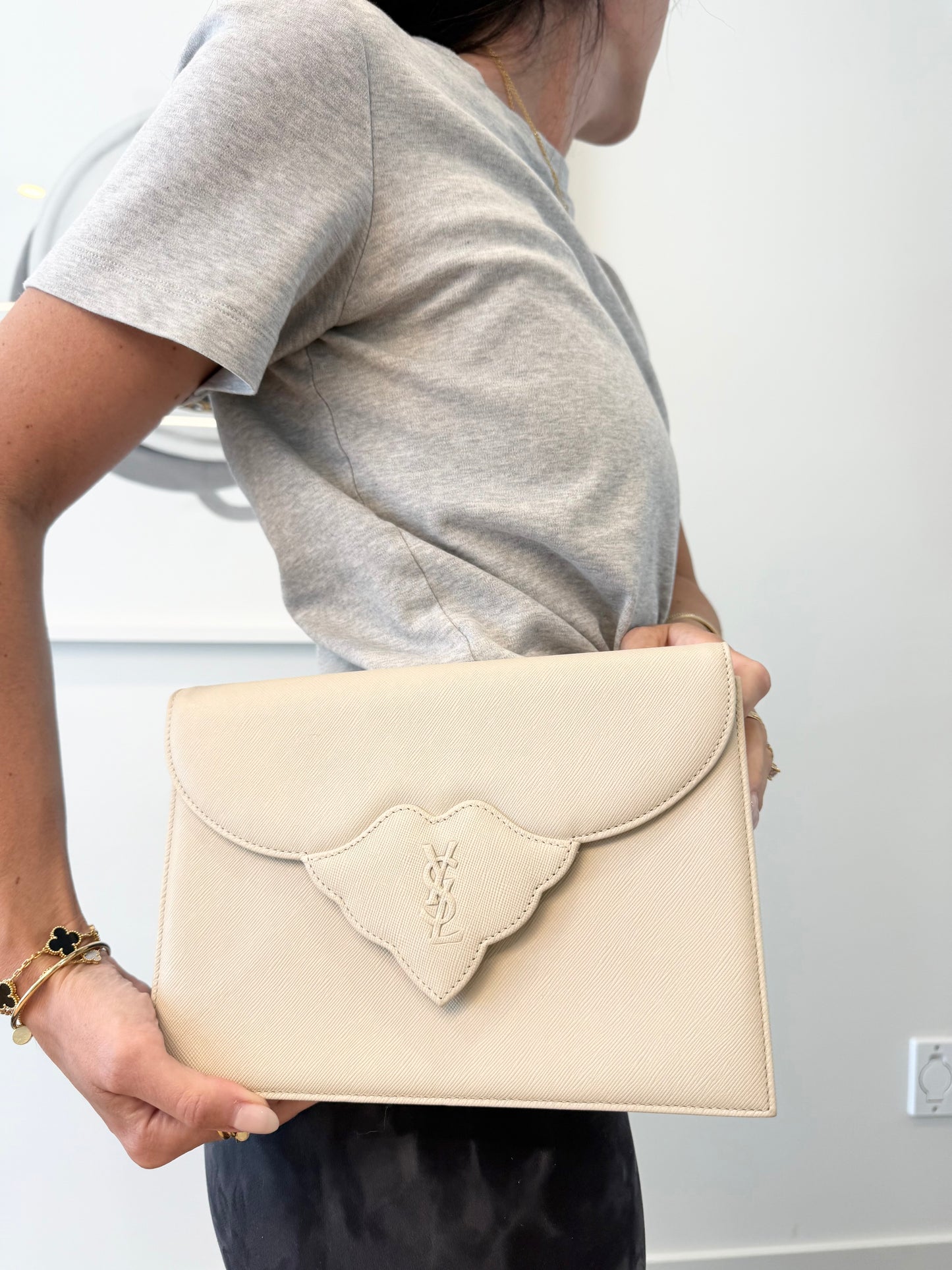 Authentic Yves Saint Laurent Ivory crossbody clutch with added removeable strap with stickers on in like new condition inside and out !