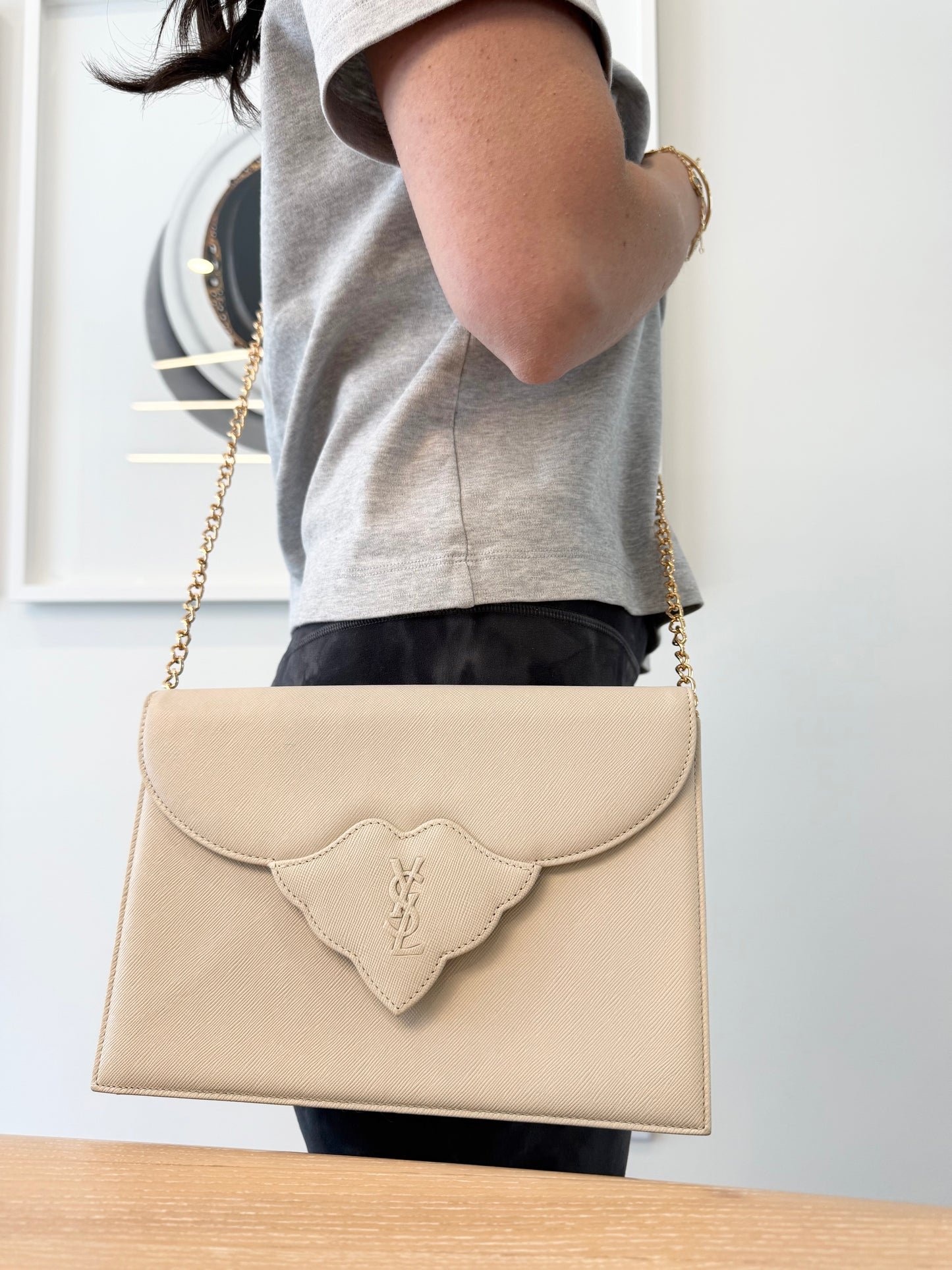 Authentic Yves Saint Laurent Ivory crossbody clutch with added removeable strap with stickers on in like new condition inside and out !