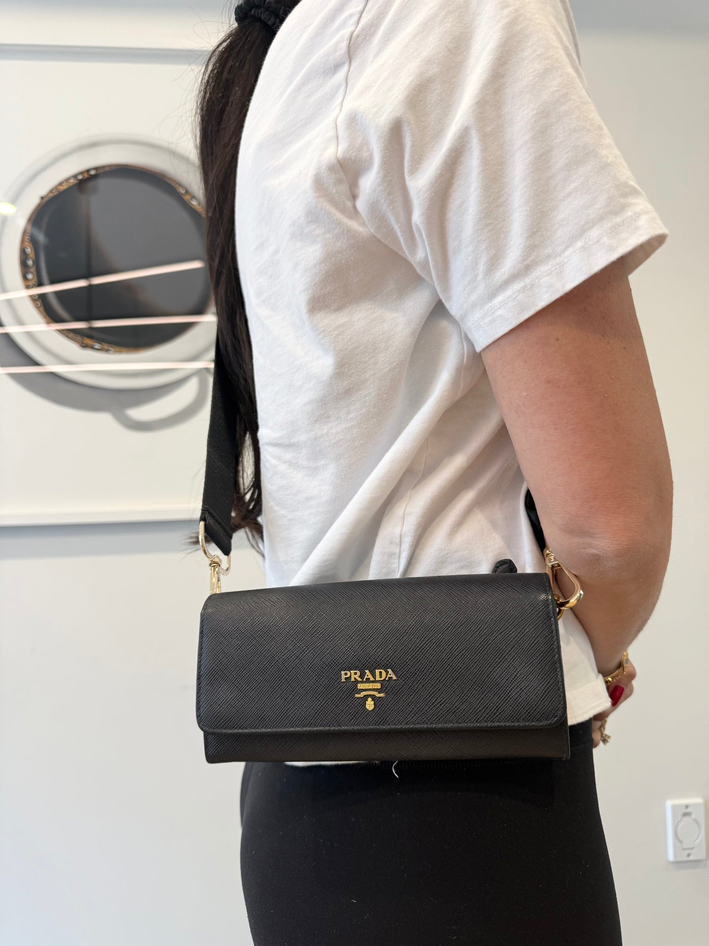 Authentic Prada saffiano wallet in box with authenticity card plus added adjustable removable strap and original cardholder ! Fits phones etc Retail $1500 plus tax!