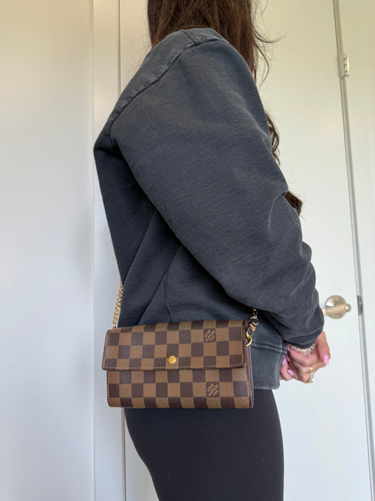 Authentic Louis Vuitton damier ebene Sarah wallet with added strap and original box . Fits phones cards cash coins
